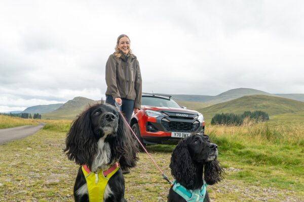 Siobhan Sellar and her two dogs with an Isuzu D-Max pick-up in the background.